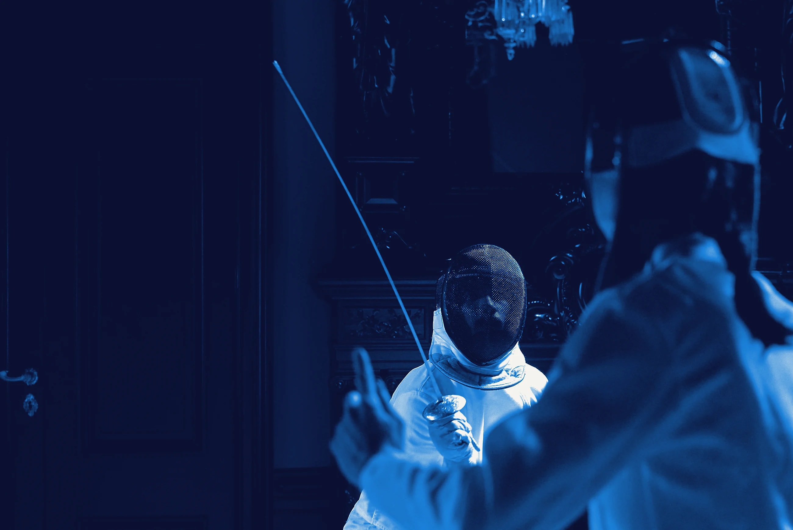 Two fencers at the moment of a touch on a dark piste.